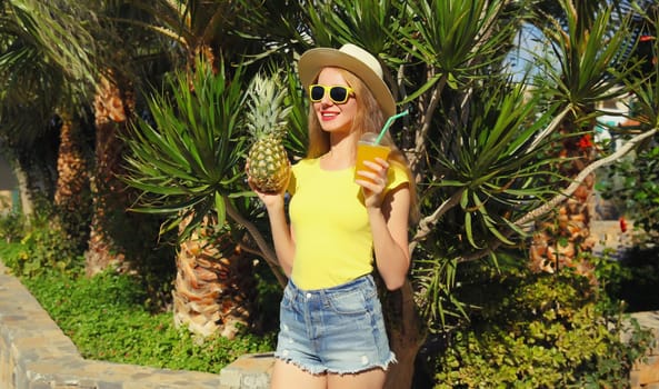 Summer vacation, tourism, happy smiling young woman with fruits, pineapple, cup of juice, joyful girl looking away in glasses, straw tourist hat posing on the beach with palm tree