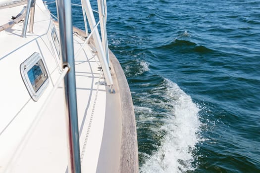 Banner with sailing in an open sea with waves. View to the side deck. Classic sailboat. Summer adventure, recreation, cruise, vacations, regatta, sport in Finland, Gulf of Finland.