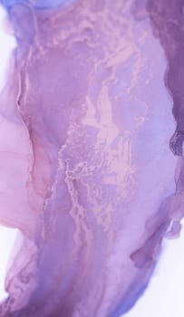 A close-up photograph of a lilac-colored ink swirl, showing delicate veins and patterns created by the flowing ink. The image captures the beauty and fluidity of abstract art.