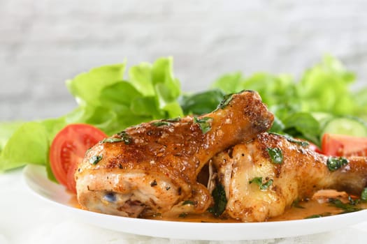 Fried chicken drumstick with gravy and vegetable side dish