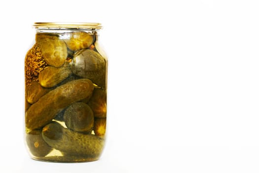 Glass jar with homemade pickled cucumbers on a white background. Copy space, close-up.