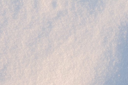 Front view of snow texture on the ground during the winter. Snow texture close-up.