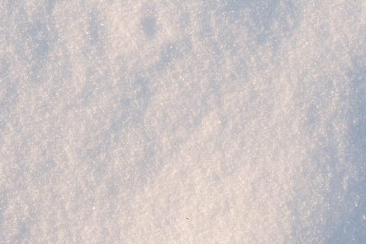 White frost snow toned in blue background. Snow texture close-up.