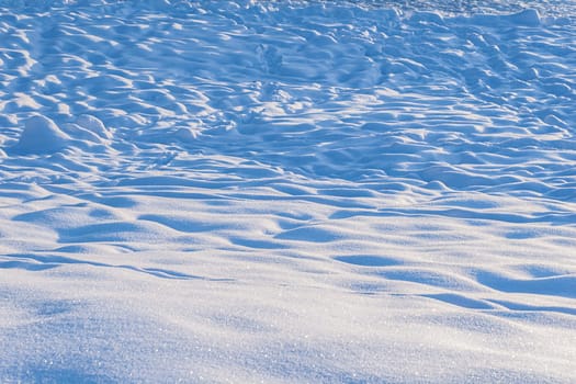Tracks in the snow. High angle view of snow covered field.