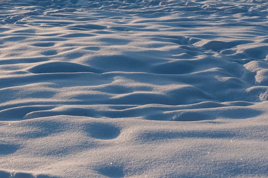 High angle view of snow covered field. Tracks in the snow.