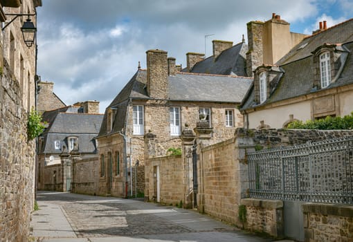 Dinan, medieval town center, Brittany, France. Dinan, traditional colorful houses on a cobbled street in medieval town center, Brittany, France