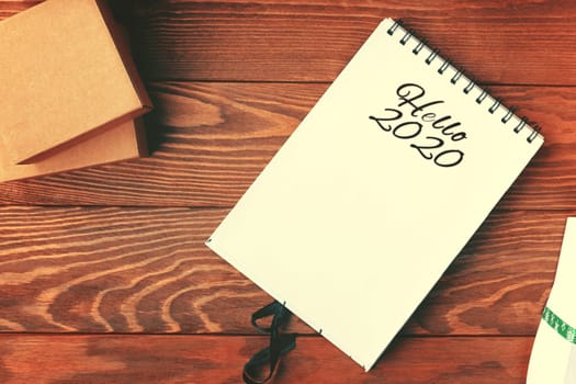 Prepare for Christmas with Notepad and gifts. Christmas background with blank notebook, decorations and gift boxes. Christmas To-Do