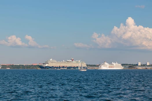 Gulf of Finland, Estonia, June 30, 2024 - Tallinn ferry port with cruise ferry boats on the dock with city of Tallinn in the background in sunny weather