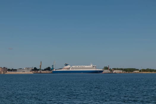 Gulf of Finland, Estonia, June 30, 2024 - Tallinn ferry port with cruise ferry boats on the dock with city of Tallinn in the background in sunny weather