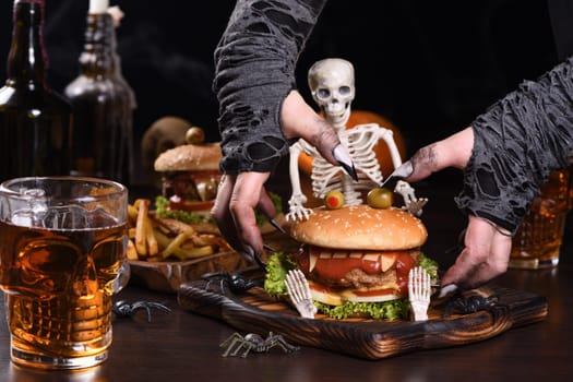 The witches hands want to grab the Monster Burger on the sitting skeleton. Perfect Halloween Party appetizer