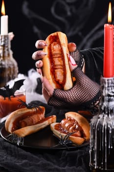  Hot dog Bloody fingers in the hands of a witch. Halloween appetizer