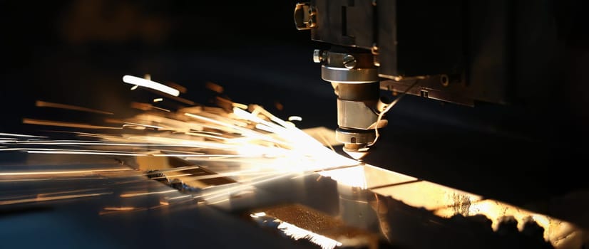 Close-up of neon sparks fly out machine head, equipment for metal processing laser metal. Cutting machine and metal plate. Automotive production concept