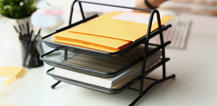 Close-up of metal holder with envelopes for further delivery, business papers. Communication, inbox, post, correspondence, business, recipient concept