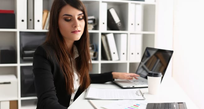 Portrait of woman secretary on workplace, busy with planning, laptop device on desk. First working day, fresh start. Clerk, secretary, office life concept
