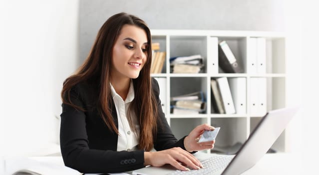 Portrait of woman type on keyboard credit card pin code, pay online, shopping on laptop from work. Online shopping, contactless payment, technology concept