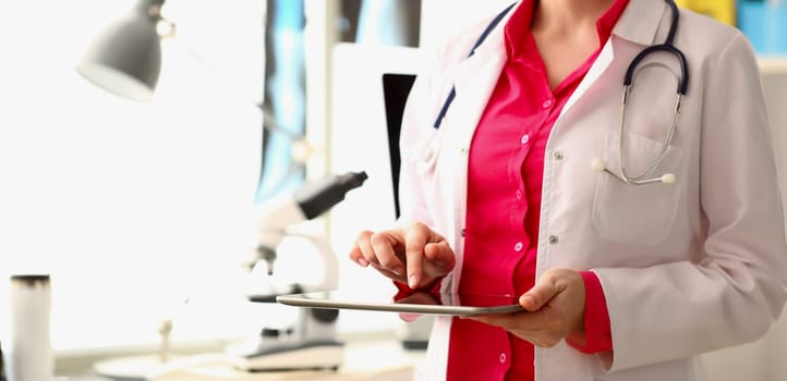Close-up of doctor open patient medical history on tablet device, modern technologies in clinic. Medicine, save life, help, emergency, appointment concept