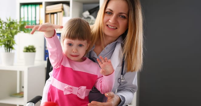 Portrait of crying little girl throw toy, doctor appointment in clinic, upset child dont like nurse. Doctor calm kid down, support. Medical, stress concept