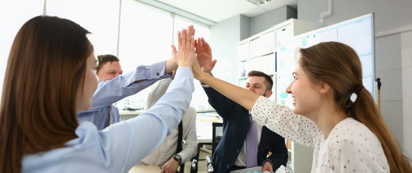 Portrait of witty colleagues performing high five gesture, successful profitable project, change future of corporation. Office party, celebration concept