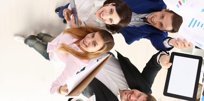 Top view of happy team celebrate end of project, successful contract, good presentation. Businesspeople proud of good job, little party. Teamwork concept