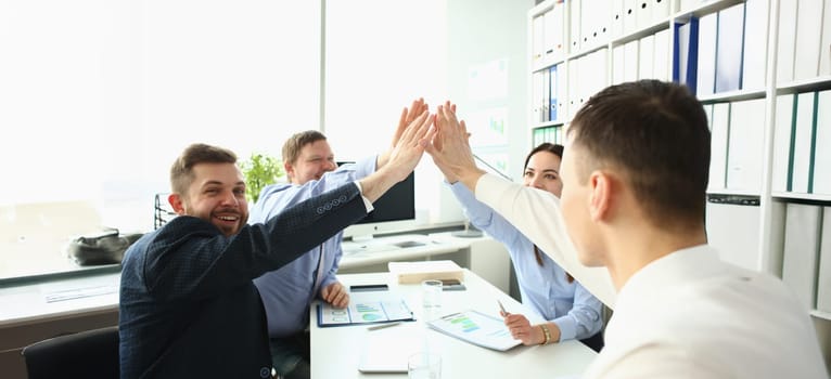 Portrait of colleagues give high five in order to celebrate successful contract, good news. Goal, success, career, new level, achievement, growth concept