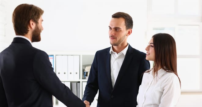 Portrait of couple shaking hands with realtor or lawyer, greet specialist in office. Appointment with consultation, qualified man. Help, advice concept