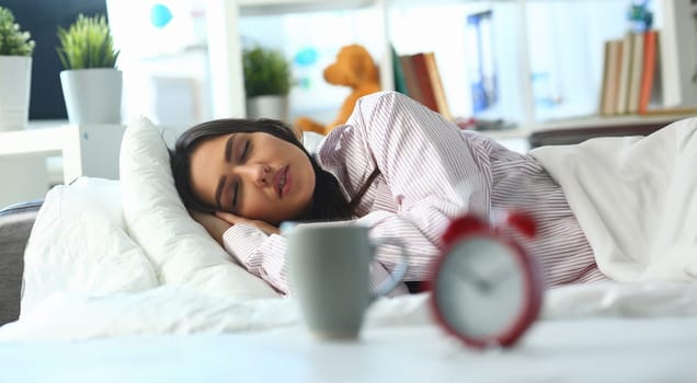 Portrait of young woman peacefully sleeping in bed, tired female, tough night, sleepless. Lady in pyjamas at home, early start. Good morning, awake concept