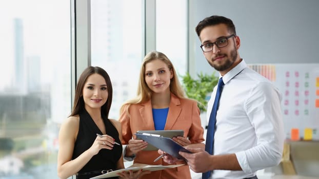 Portrait of confident team of successful people, men and women employees pose for collective picture. Coworkers in trendy suits. Business, teamwork concept