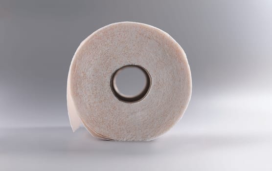 Close-up of white roll of soft toilet paper, clean tissue for personal hygiene. Unused paper for bathroom or toilet. Hygiene, sterile, cleaning concept