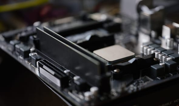 Close-up of tiny silver detail in computer processor, computer motherboard with all component. Modern technology, tech, electronics, maintenance concept