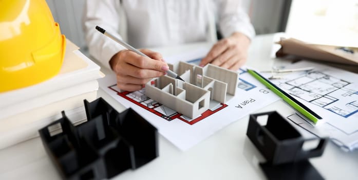 Architect shows layout of house or apartment. Design and construction of housing concept