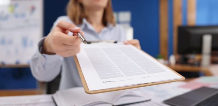Close-up of businesswoman give silver pen to client to put signature on contract paper. Prepared business document for client. Business, agreement concept