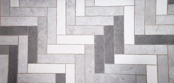 Top view of seamless black white and grey mosaic marble floor tile texture in geometric shape pattern. Monochrome tone design. Interior concept. Copy space
