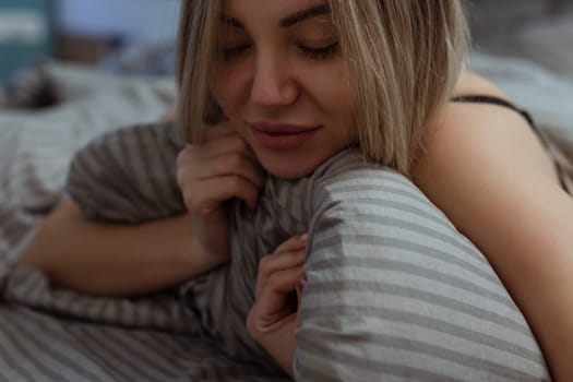 Female orgasm .A lonely sexy girl in her underwear lies on the bed on her face pleasure. Masturbation and oral sex.