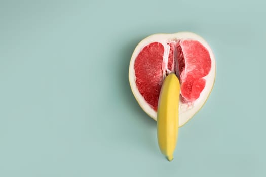 Banana and grapefruit flat lay minimal composition . A metaphor of sex, sexuality, vagina and penis.