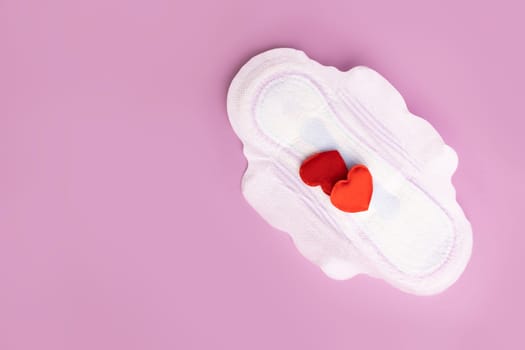 Menstruation and critical days. Gasket for menstruation on which there are two hearts in the form of blood drops.
