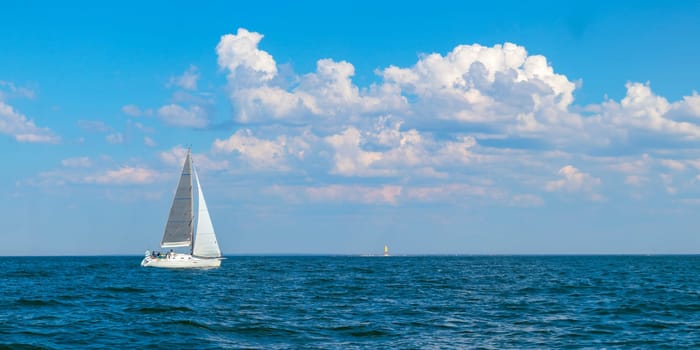 Yacht, white sailboat under head genoa and main sails sailing in an calm open sea. Cruise, vacations, regatta, sport. Gulf of Finland