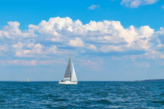 Yacht, white sailboat under head genoa and main sails sailing in an calm open sea. Cruise, vacations, regatta, sport. Gulf of Finland