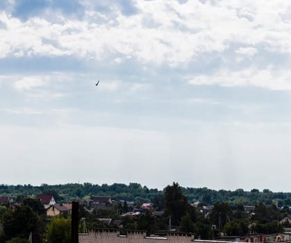Silhouette of the MIG fighter jet in the cloudy sky