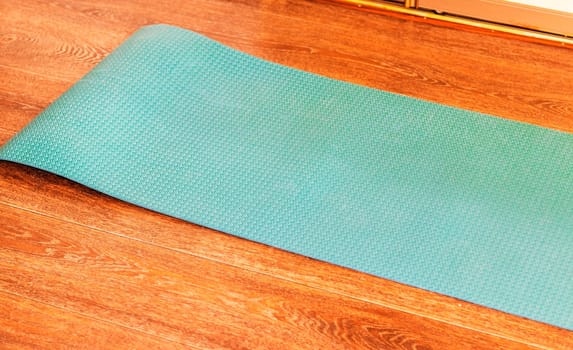 Concept shot of the yoga mat on the floor of the apartment