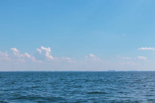 Tallinn silhouette from distance - sea side. Baltic sea Tallinn bay in front. Clear summer weather - July in Estonia.