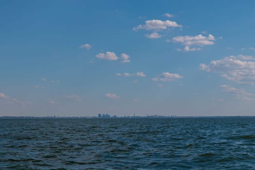 Tallinn silhouette from distance - sea side. Baltic sea Tallinn bay in front. Clear summer weather - July in Estonia.