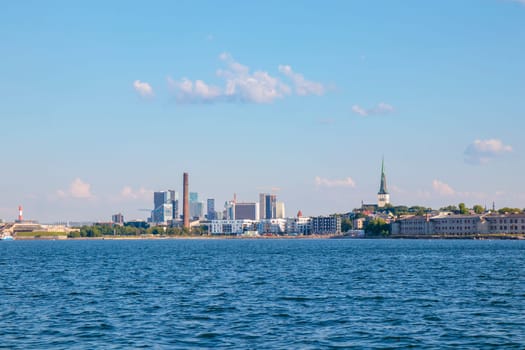 Tallinn silhouette from distance - sea side. Baltic sea Tallinn bay in front. Clear summer weather - July in Estonia.