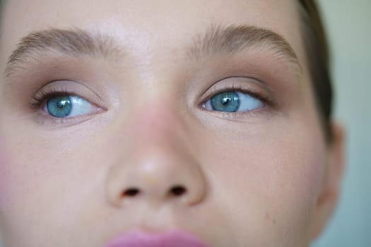 Close-up of a caucasian woman with blue eyes indoors