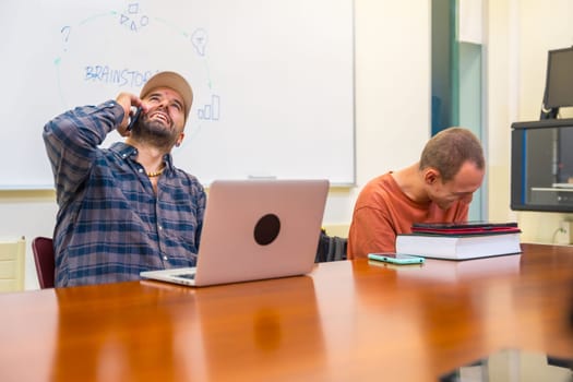 Happy successful inclusive teamwork with a man with cerebral palsy in a modern coworking