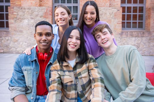 multiracial five students gathering on campus. concepts of youth, university life, adolescent and urban life