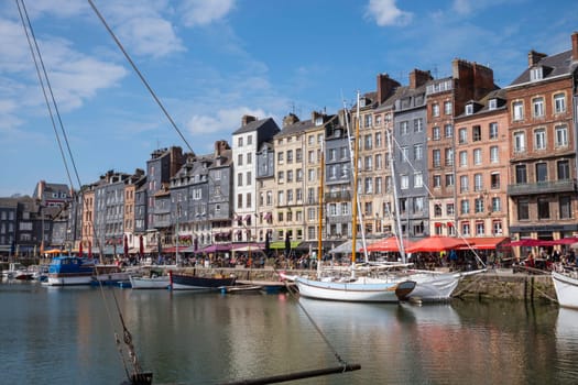 Honfleur, Normandy, France - 25-04-2024: People Sitting on the Terrace of the Restaurant. Port of Honfleur in the Calvados department in northwestern France