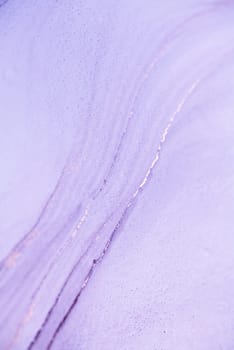 A close-up shot of purple ice with a delicate pattern of light reflecting off its surface.