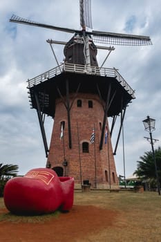 A dutch windmill with a dutch shoe in the foreground. touristic attraction in Holambra, SP Brazil. June 30, 2024.