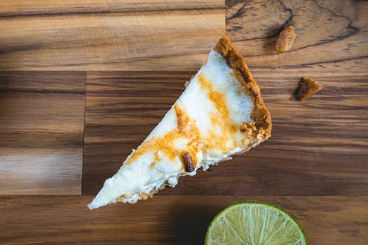 A home made Lemon pie, on a wooden plate. Decorated with lemons.