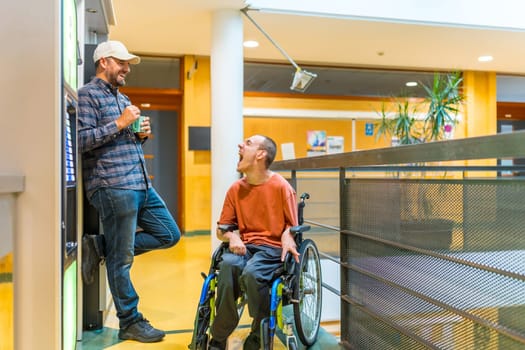 Man with disability and colleague next to a vending machine in a coworking